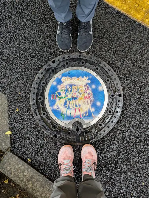 Life Of Doing's feet around the blue manhole cover of the Sailor Guardians from Sailor Moon animation
