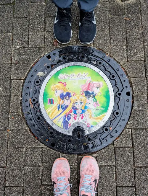 Life Of Doing stands around the green manhole cover of the Sailor Moon's Sailor Guardians
