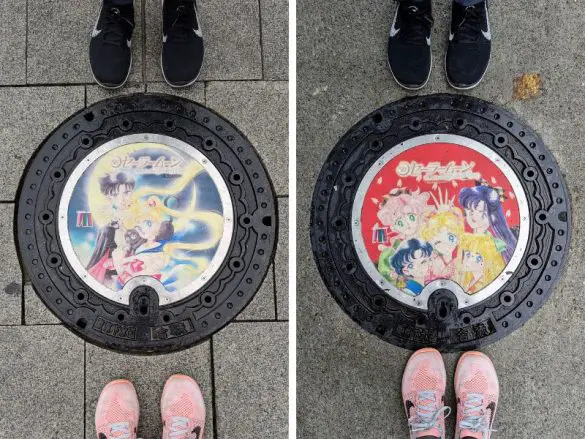 Two manhole Sailor Moon covers in Tokyo, Japan - one blue and one red