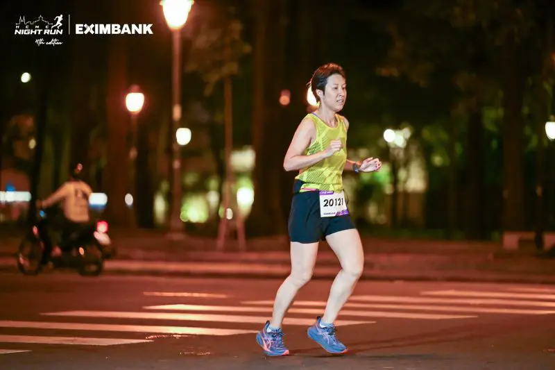 Jackie Szeto, Life Of Doing, runs past the park at the HCMC Night Run