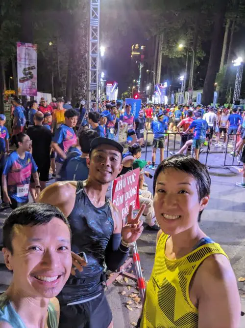 Justin Huynh, Jackie Szeto, Life Of Doing, and Eddie, a friend, at the start line of the Ho Chi Minh City Night Run Eximbank 2025