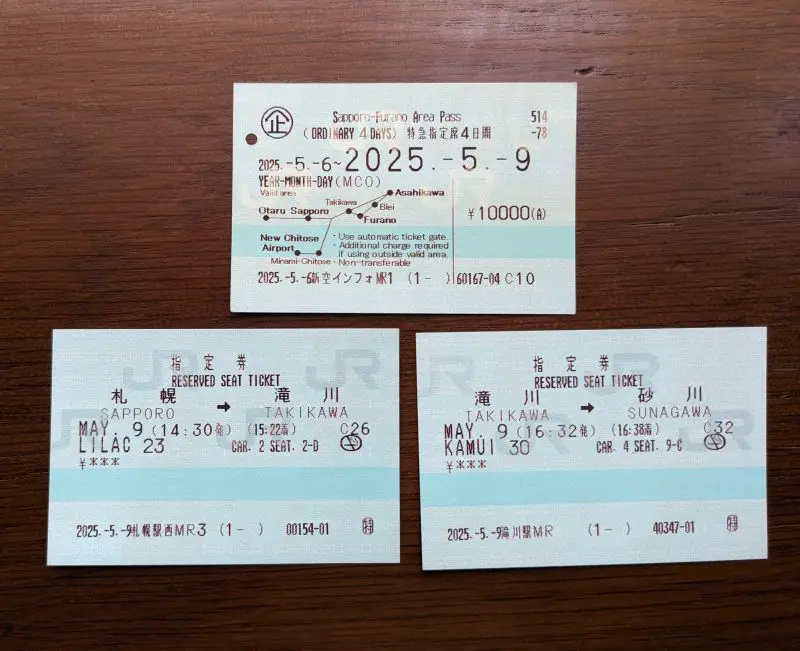 Japan Railways Sapporo Furano Area ticket on top, and two reserved seating tickets on the bottom