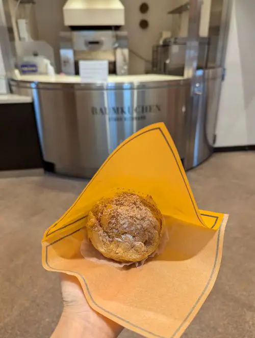Jackie Szeto, Life Of Doing, holds a cream puff from Kitakaro Otaru Main Shop in Otaru, Hokkaido