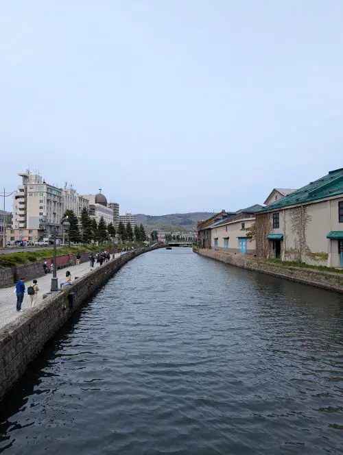 People walk along the Otaru Canal in Otaru, Hokkaido, Japan