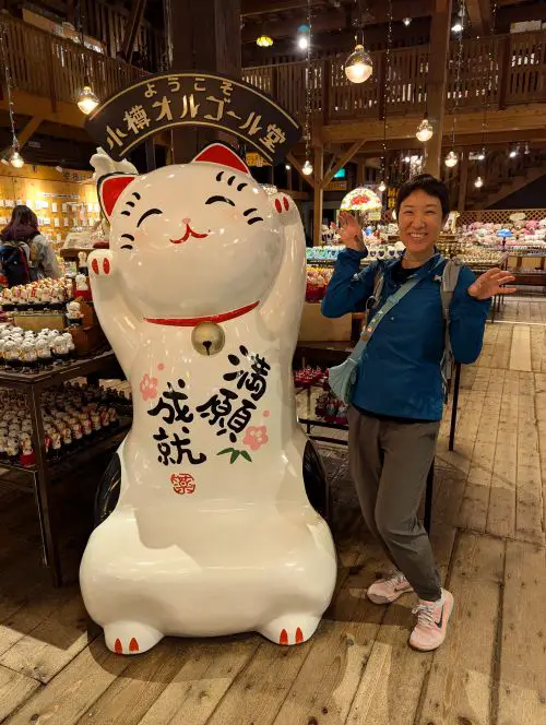 Jackie Szeto, Life Of Doing, has her hand outwards like the Lucky Cat statue at the Otaru Music Box store in Otaru, Hokkaido