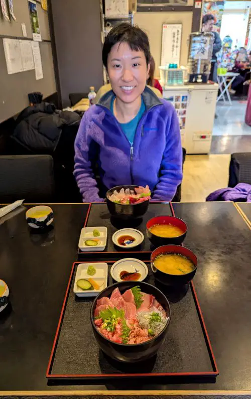 Jackie Szeto, Life Of Doing, smiles with her fresh sashimi rice bowls at Donbei, one of the restaurants at Shimizu Fish Market, Shizuoka, Japan