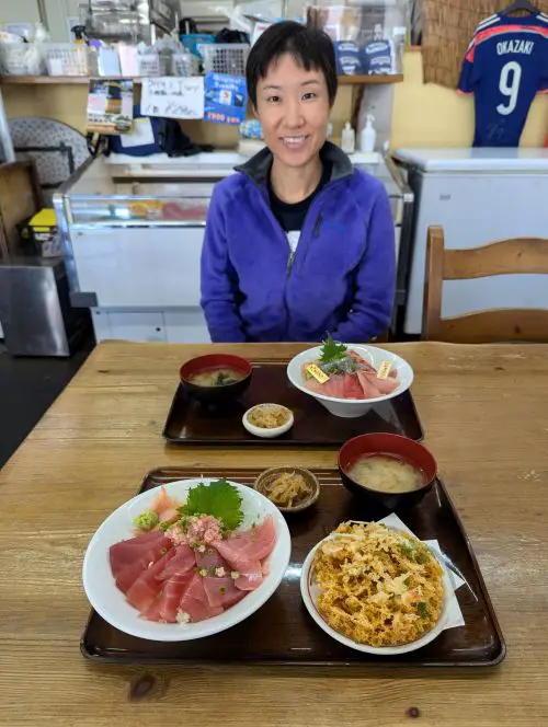 Jackie Szeto, Life Of Doing, has two tuna seafood bowls in front of her at Miyamoto Shoten at Shimizu Fish Market, Shizuoka, Japan