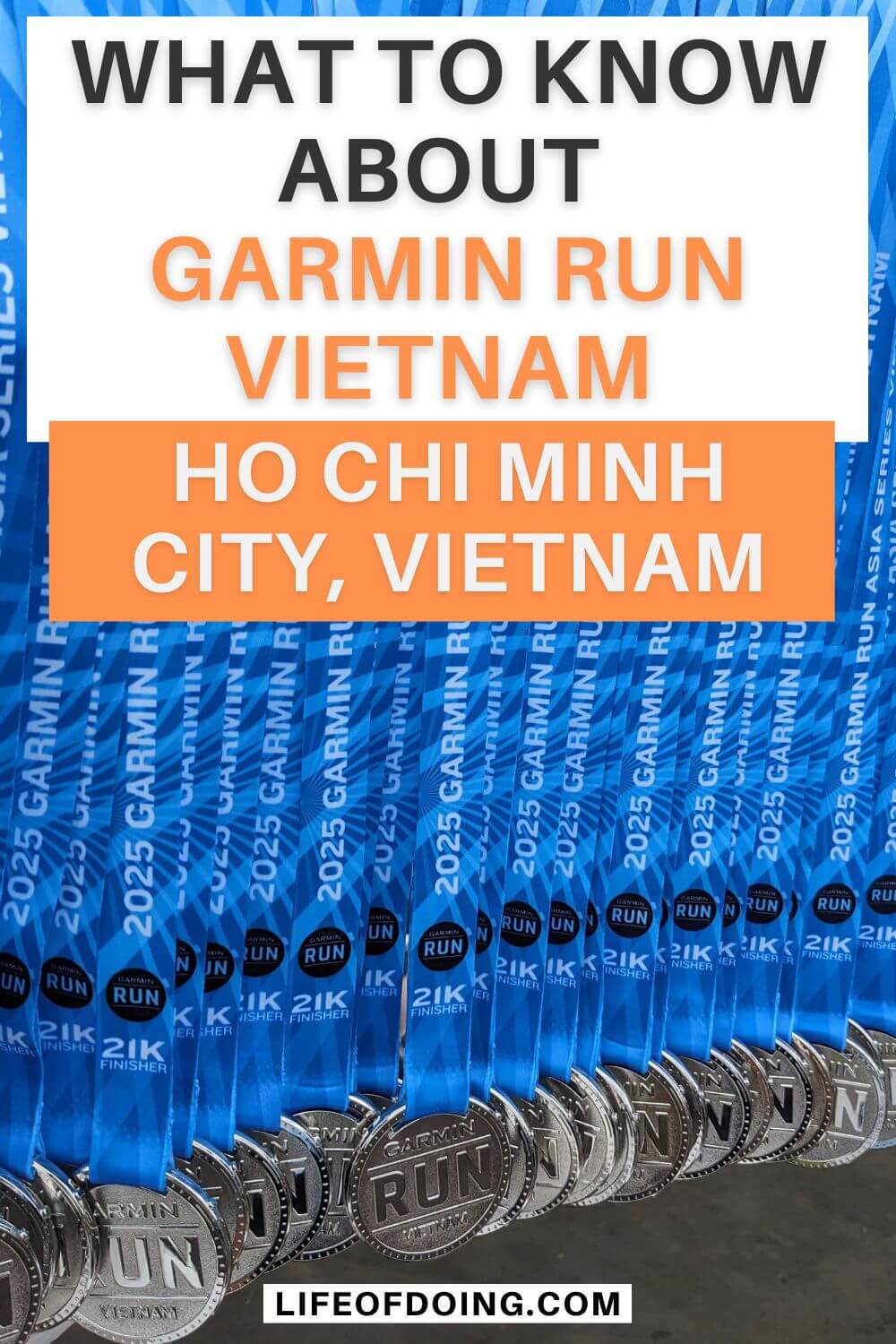 A medal rack holding dozens of finisher's medals for the Garmin Run Vietnam 2025 race