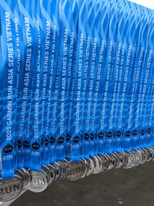 A row of Garmin Run Vietnam 21km finisher medals waiting to be distributed to runners