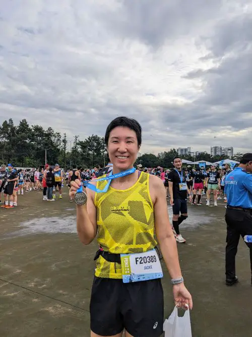 Jackie Szeto, Life Of Doing, finishes the Garmin Run Vietnam race and holds her finisher medal