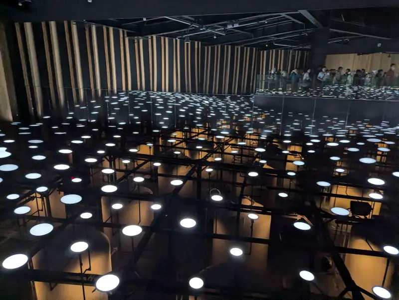 White circles of light that are actually microorganisms fermenting waste from the Japan Pavilion