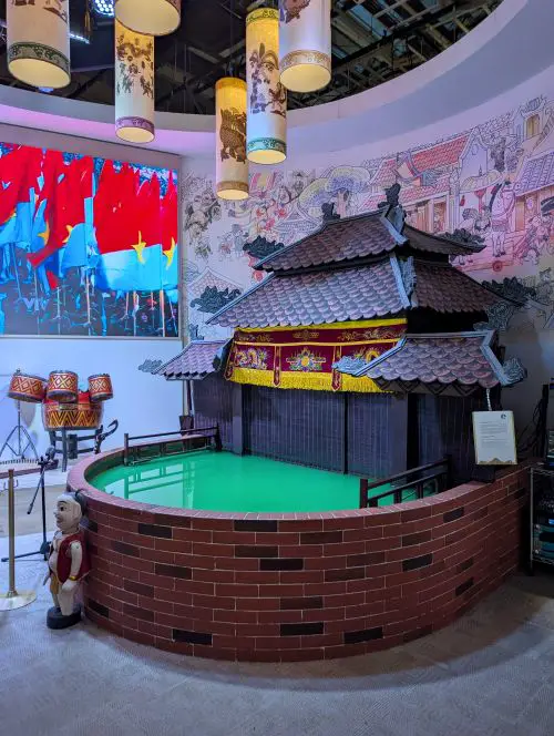 A mini Water Puppet theater with a small pond of water and a stage for the in person show at the Vietnam Pavilion