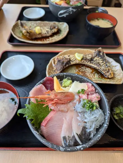 A rice bowl topped with fresh seafood such as raw shrimp, whitebait, and tuna at Totosuke in Shimizu Fish Market