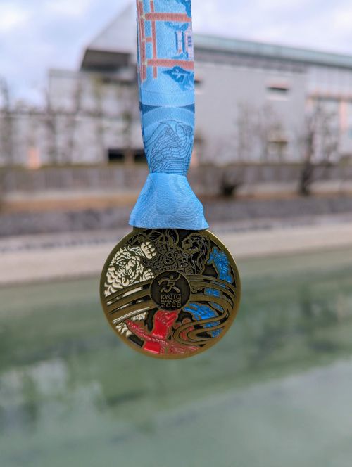 Kyoto Marathon 2026 finisher medal that has four deities - Azure Dragon, White Tiger, Vermillion Bird, and Black Tortoise