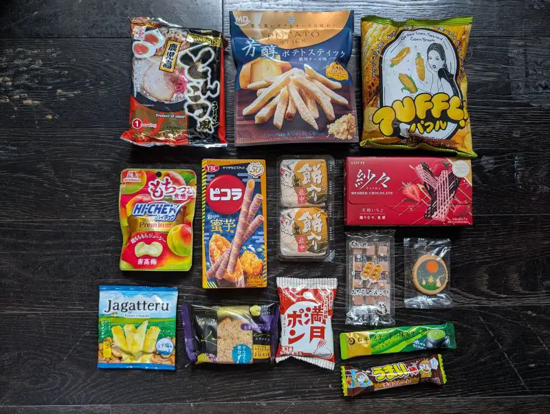 An overlay of the 14 TokyoTreat snacks received such as Hi-Chews, corn snacks, chocolate, and more